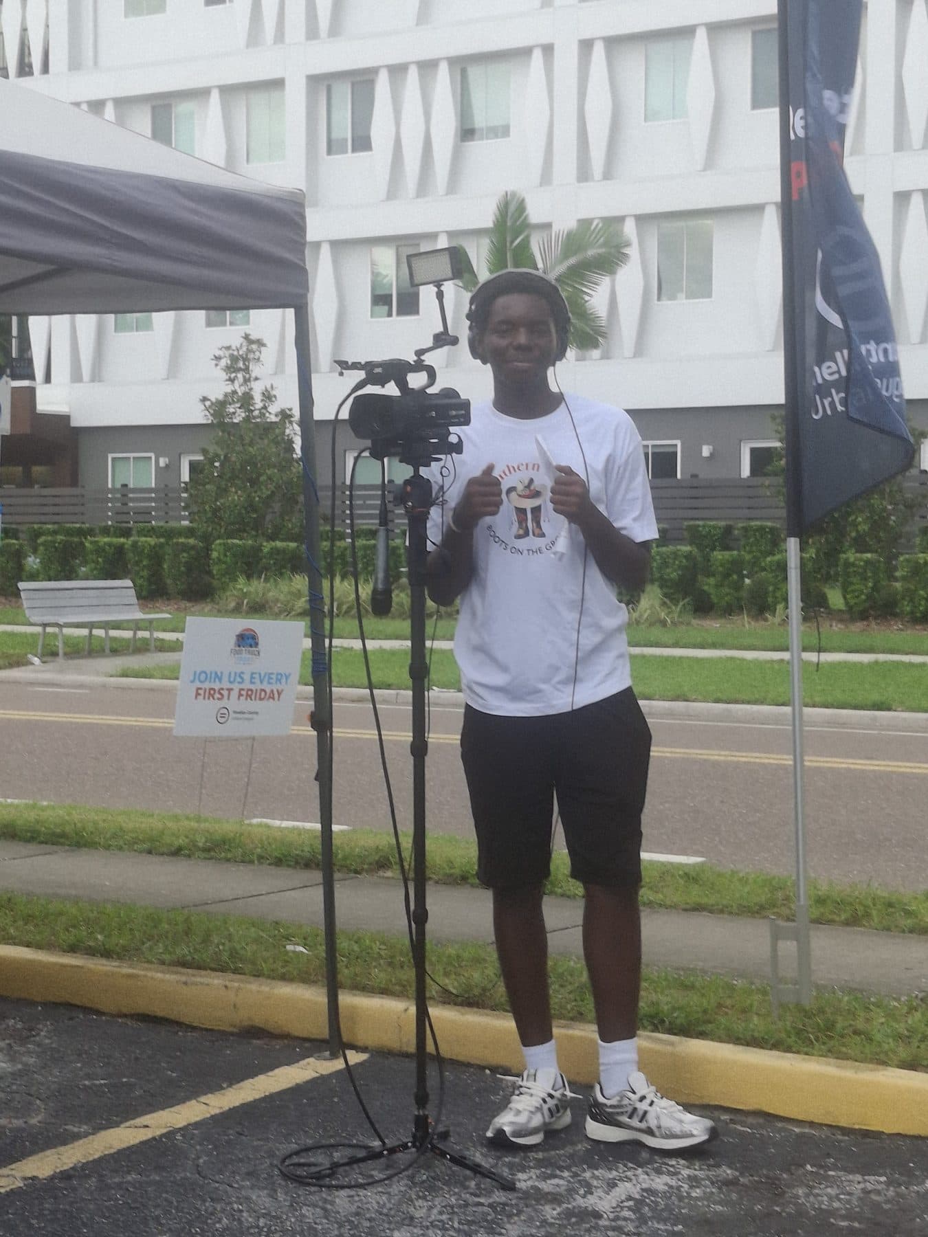 A participant speaking into a microphone at a First Friday community event